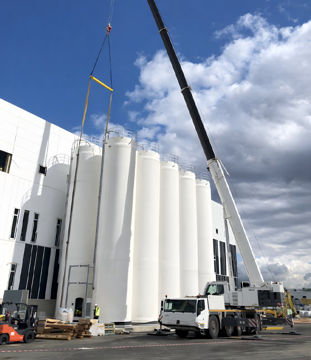 Mobile crane lifting equipment at an industrial facility